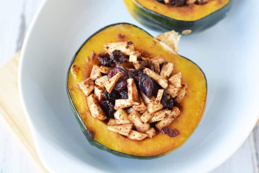 baked sweet acorn squash on a white plate