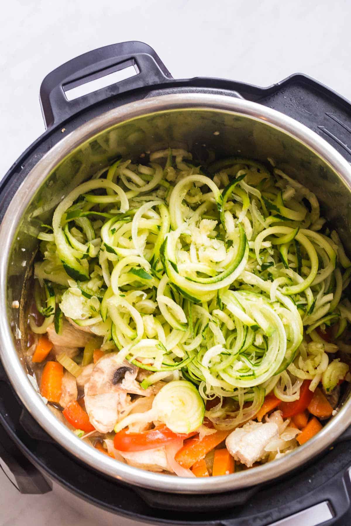 raw zoodles and cooked chicken lo mein in the instant pot