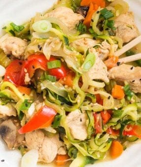 top down view of instant pot chicken lo mein with zoodles in a white bowl and chopsticks