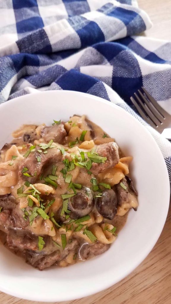 close up of stroganoff in white bowl