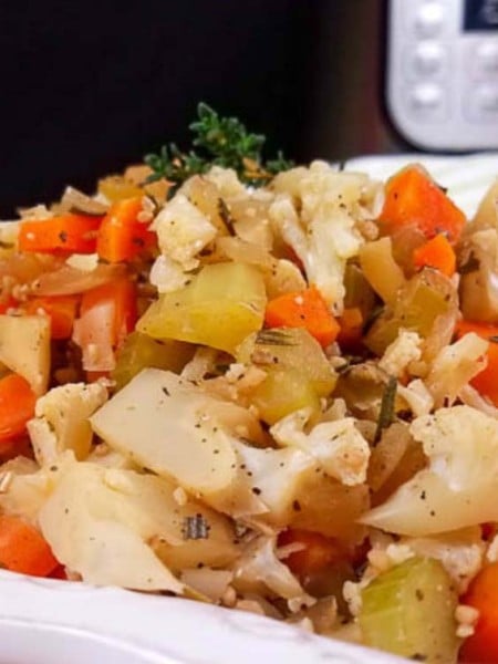 This low carb Cauliflower Stuffing can be made in the Instant Pot or in the oven, and is the perfect Thanksgiving side dish! All of the delicious stuffing flavors with less carbs and calories than your traditional stuffing recipe–that means I can eat more! Vegan Stuffing Recipe | Low-Carb Stuffing Recipe | Holiday Side Dish | Roasted Cauliflower Rice Stuffing | Healthy Cauliflower Rice Recipes #stuffing #thanksgiving #healthy