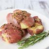 rosemary smashed potatoes with garlic on a white plate