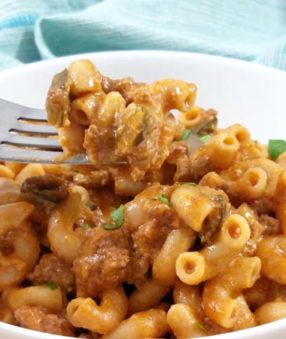 hamburger helper on fork in white bowl