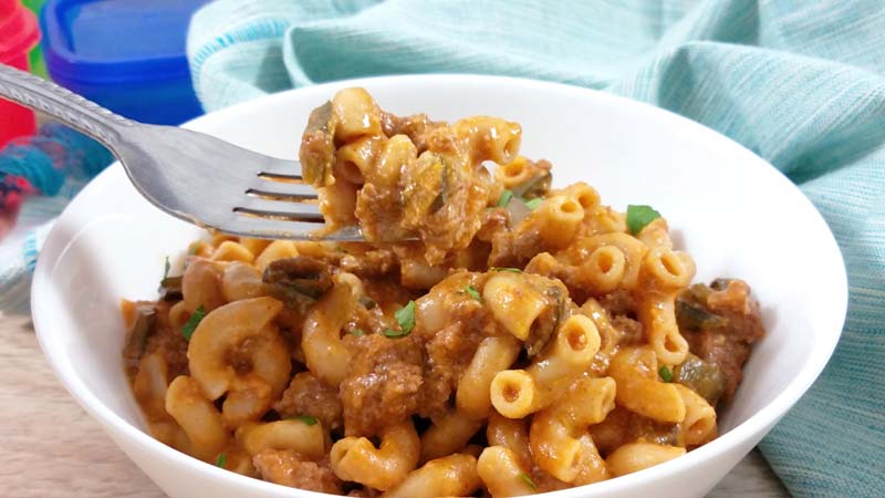 hamburger helper on fork in white bowl