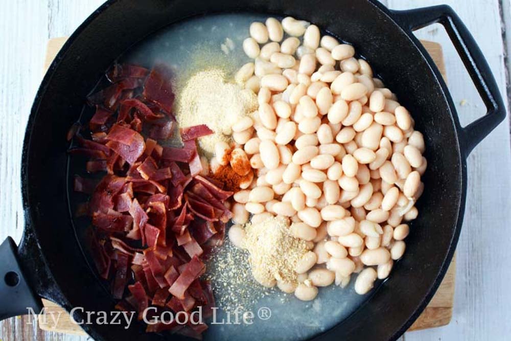homemade pork and beans ingredients in a cast iron skillet