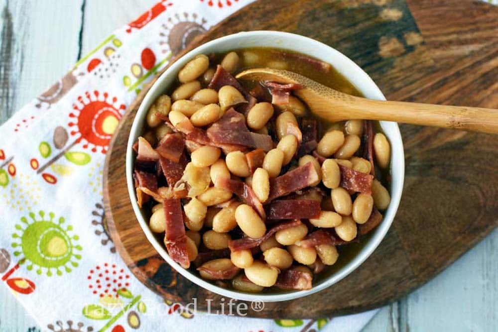 homemade pork and beans in a white bowl
