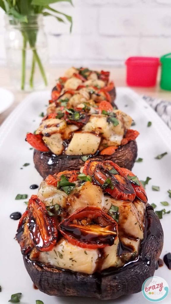 These Caprese Chicken Stuffed Portobello Mushrooms are a delicious lunch or dinner! A large portobello mushroom topped with a caprese chicken inspired mixture can be easily baked for a healthy dinner. I love how hearty and versatile portobello mushrooms are! Stuffed Portobello Mushroom Recipes | Mushroom Recipes | Portobello Recipes