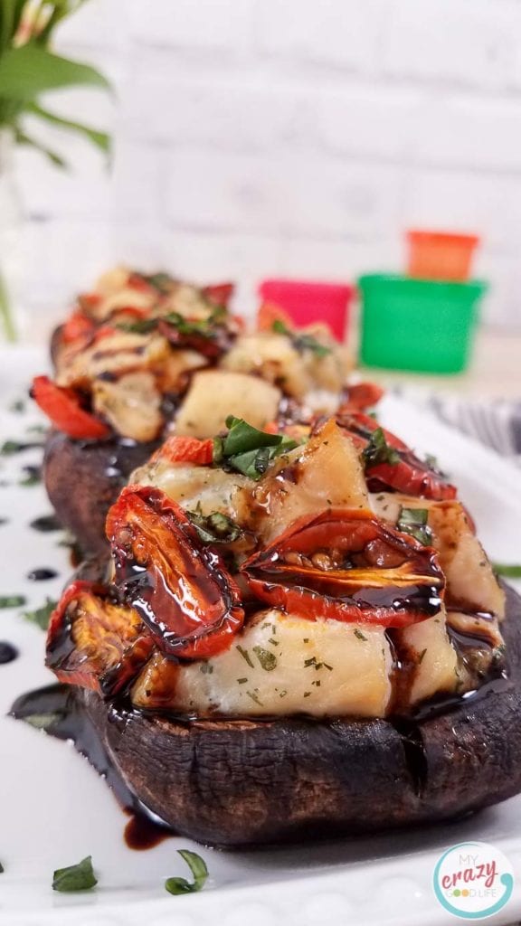 These Caprese Chicken Stuffed Portobello Mushrooms are a delicious lunch or dinner! A large portobello mushroom topped with a caprese chicken inspired mixture can be easily baked for a healthy dinner. I love how hearty and versatile portobello mushrooms are! Stuffed Portobello Mushroom Recipes | Mushroom Recipes | Portobello Recipes