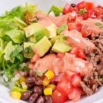 This Carne Asada Burrito Bowl includes a recipe for Homemade Creamy Chili Lime Dressing that's going to be your next favorite healthy dressing recipe! Citrus-seasoned Carne Asada and delicious vegetables and black beans make a delicious Mexican dinner for your Carne Asada leftovers!
