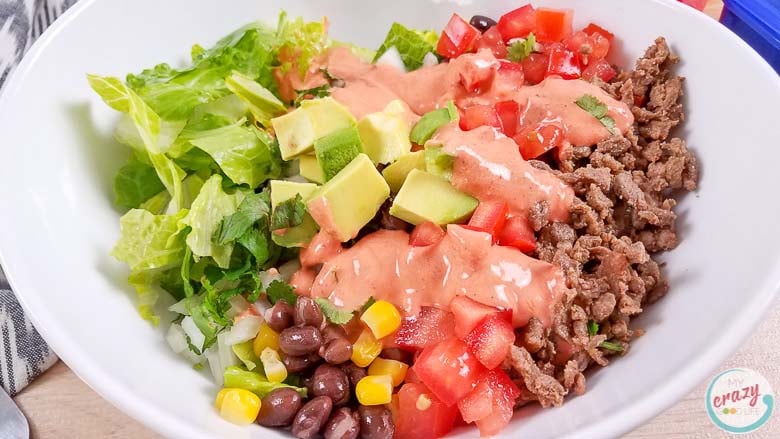 burrito bowl with dressing in a white bowl