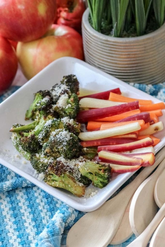image of air fried broccoli with parmesan and colored carrots on white plate