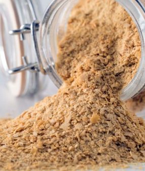 What is nutritional yeast? Also called nooch, it's an inactive yeast that many people use on their food. It has a nutty, cheesy flavor and is often used in vegan recipes. Use it on popcorn, as a breading, and as a soup thickener. Here are some uses and recipes for nutritional yeast!