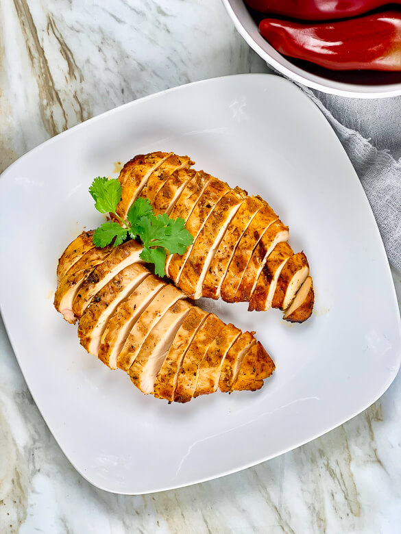 grilled and sliced chicken on a white plate