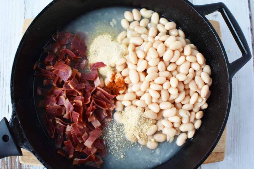 skillet with ingredients to make healthy pork and beans