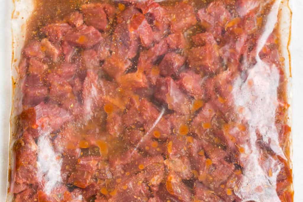 bag full of diced skirt steak in carne asada marinate
