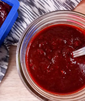 top down image of homemade red enchilada sauce in clear mason jar