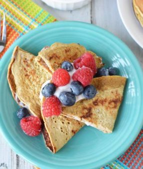 image of healthy crepes with fruit and greek yogurt on a turquoise plate