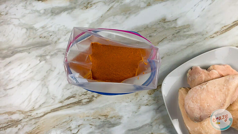 zipper bag of marinade and frozen chicken