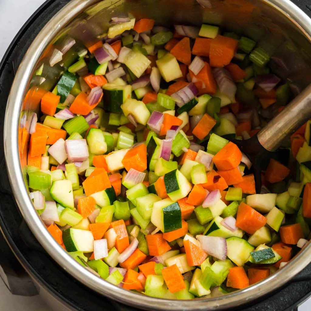 Open Instant Pot with chopped vegetables for Minestrone Soup inside.