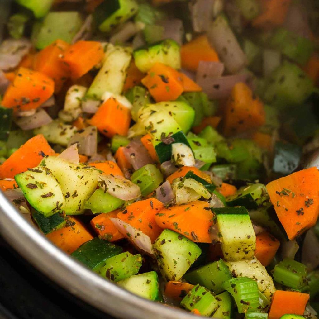 Instant Pot with cooked vegetables and spices for Minestrone Soup.
