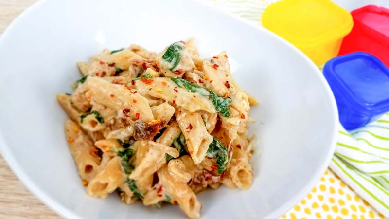 tuscan chicken pasta in a white bowl