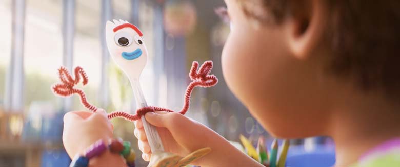 image of Forky character bring held by girl