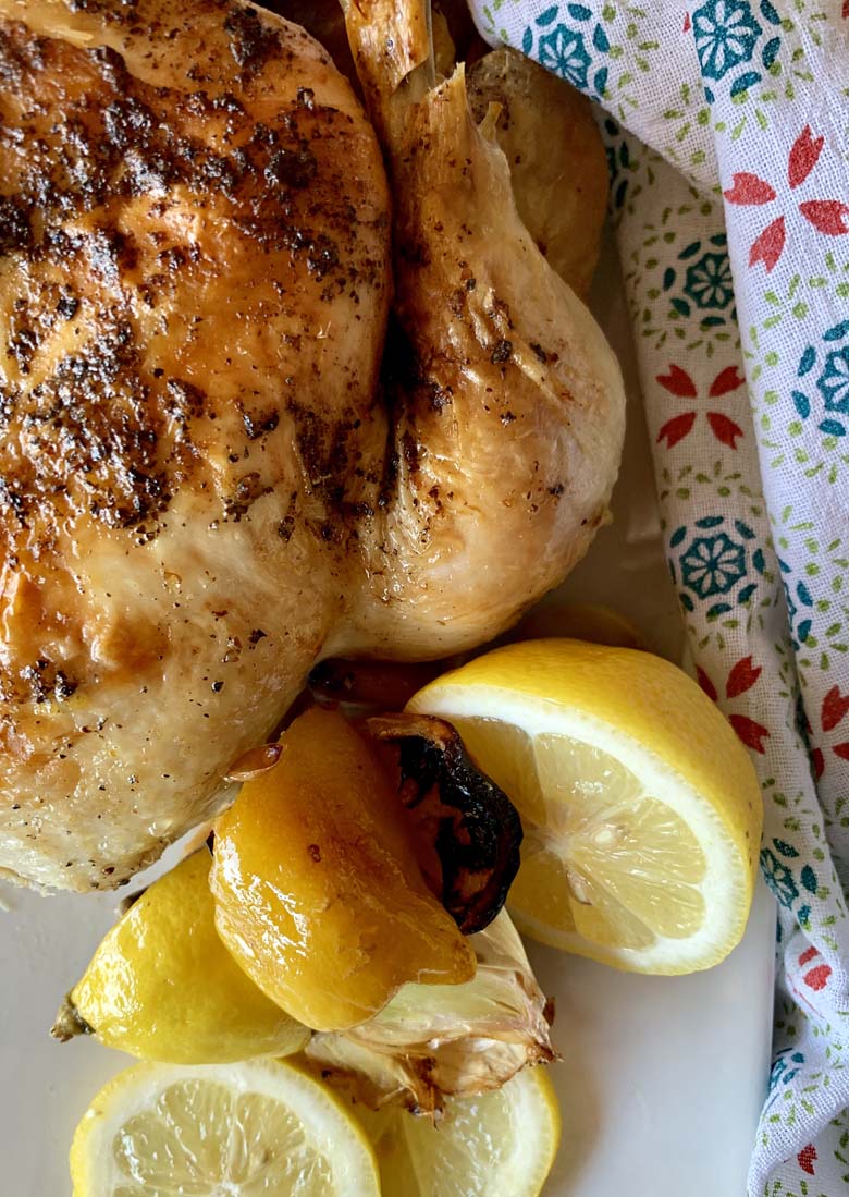 cooked whole chicken on white platter