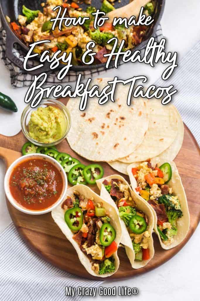 breakfast tacos on a wood platter with tortillas and veggies and text for pinterest