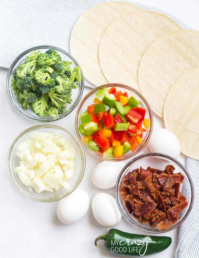 ingredients needed for breakfast tacos on a white counter