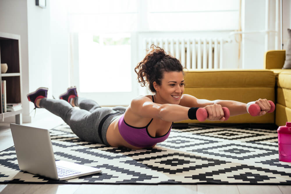 Woman working out at home with weights.