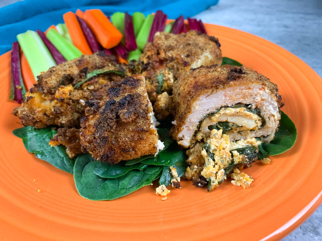 chicken roll ups on an orange plate