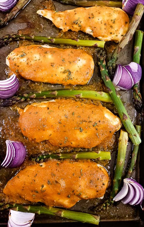 chicken and asparagus shown on sheet pan.