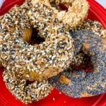 wheat bagels on a red plate, close up