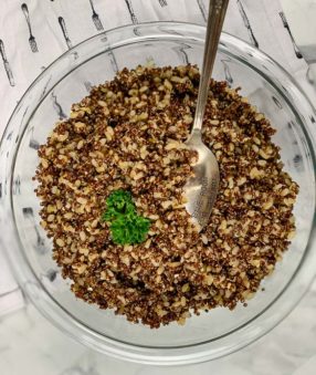 top down image of clear bowl with quinoa and brown rice