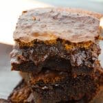 A stack of cut espresso brownies showing a gooey center.