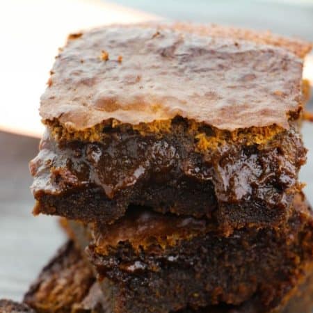 A stack of cut espresso brownies showing a gooey center.