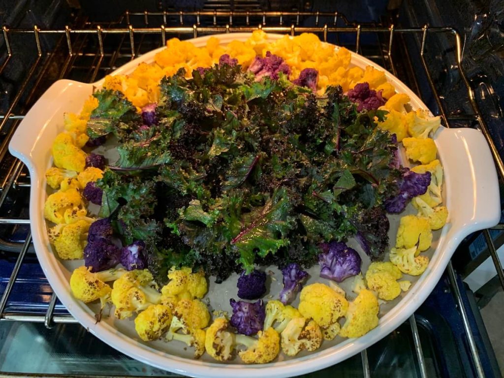 Roasted veggie tray going into the oven to cook.