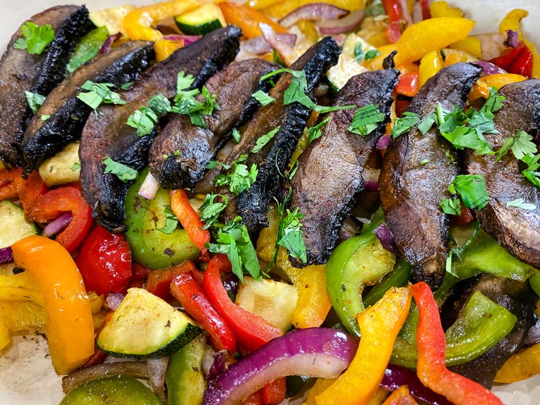 close up of mushrooms and other fajita vegetables