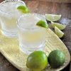 Two norcal margaritas sit on gold platter.
