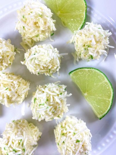 white plate with coconut bites and lime slices