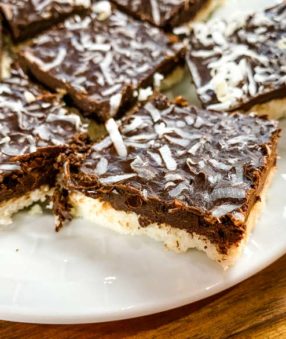 close up if coconut bars on white plate