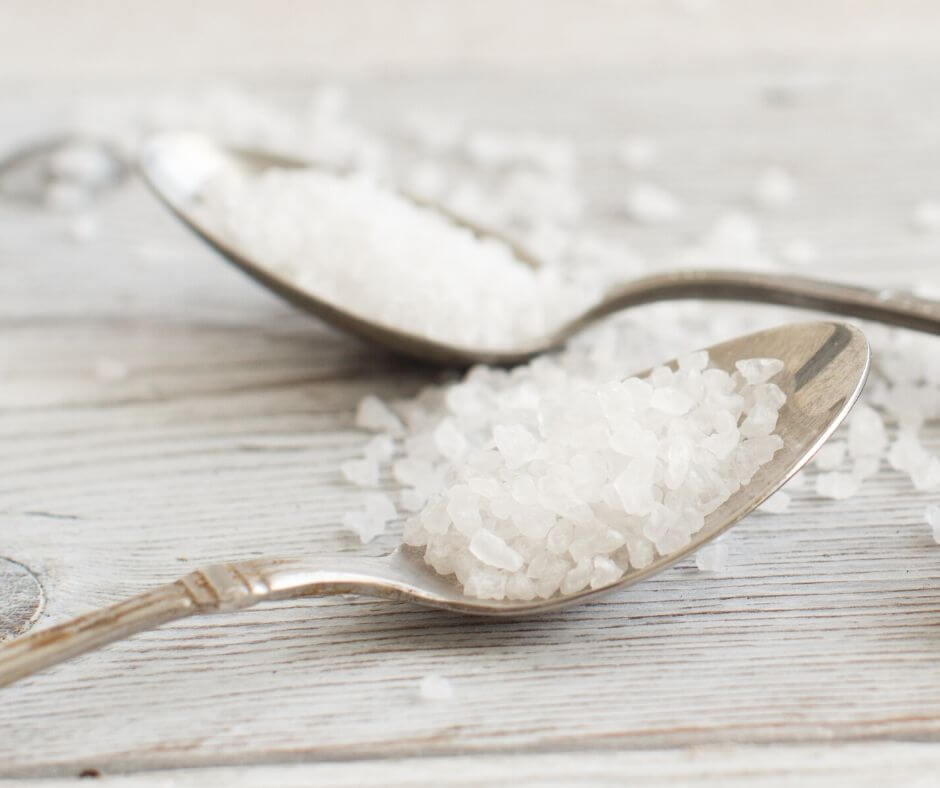 Salt on a metal spoon.