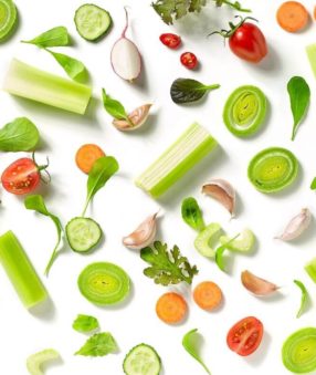 featured image for high fiber vegetables post with vegetables laid out on white backdrop.