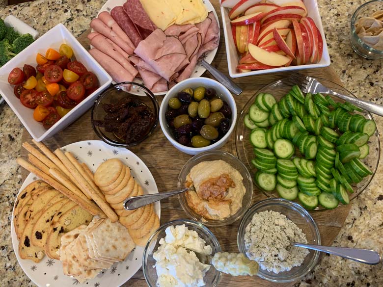 appetizers and snacks on a wood platter