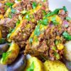 close up of sliced meatloaf with roasted potatoes