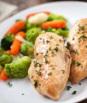 grilled chicken and veggies on a white plate