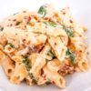 tuscan chicken pasta in white bowl