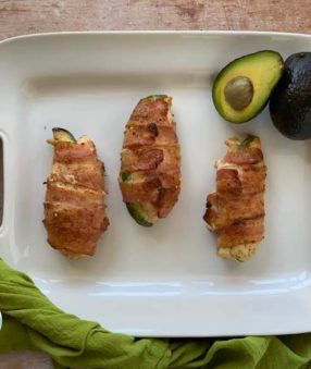 top down image of bacon wrapped chicken on a white platter