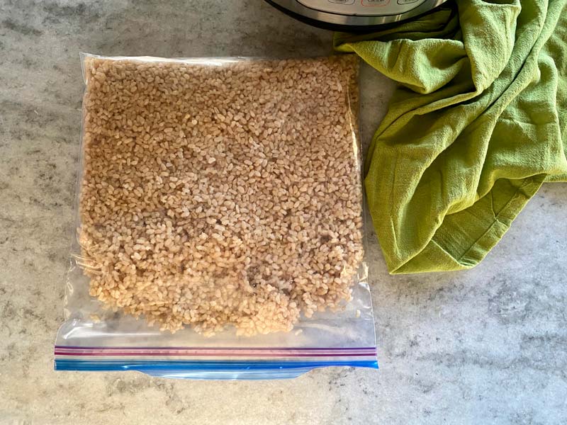 brown rice in a freezer bag on counter with green towel