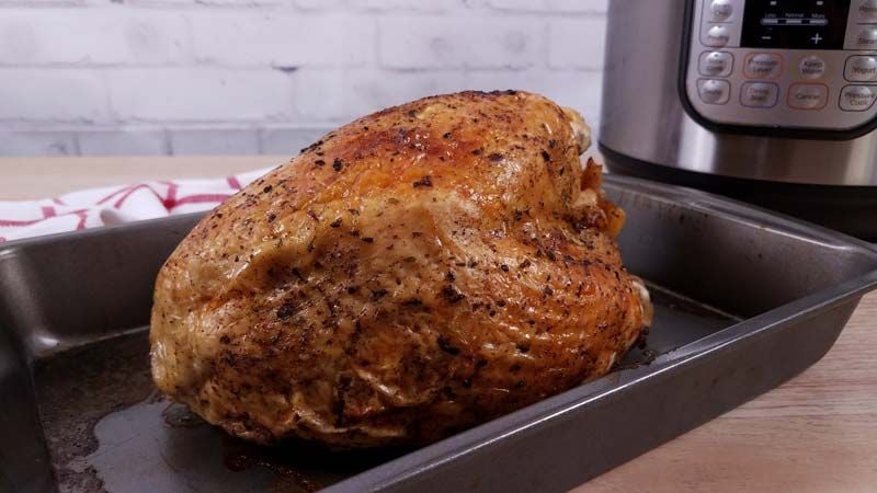cooked turkey breast in roasting pan